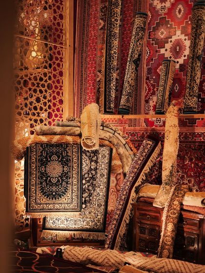 A corner of our recreated rug market for the Sufi sangeet. We sourced and layered dozens of carpets and rugs, rolling them and draping them to create the look and feel of a bustling Moroccan souk.