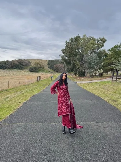 Another shot of the Juno Kurta set in action. The rich red color and detailed embroidery stand out beautifully against the winter landscape.