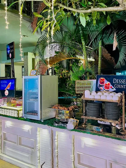 A dedicated dessert counter at an outdoor event. This setup ensures guests can easily access a variety of sweet treats while enjoying the party atmosphere.