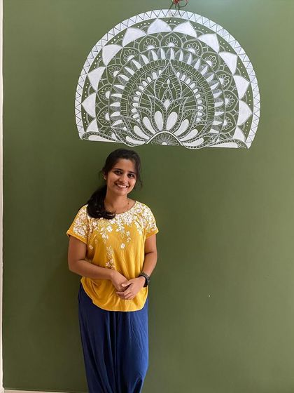 This semi-mandala was uniquely designed to wrap around a corner. The intricate white details on the olive green wall create a beautiful and continuous piece of art that flows from one space to another.