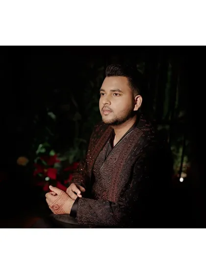 A portrait of the groom before the Sangeet festivities. His Shantanu & Nikhil bandhgala features a deep, rich texture that's perfect for an evening event.