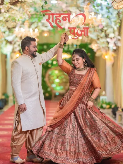 A beautiful action shot of Rohan twirling Pooja on the dance floor at their engagement. Her lehenga looks stunning in motion, creating a dynamic and joyful photo.