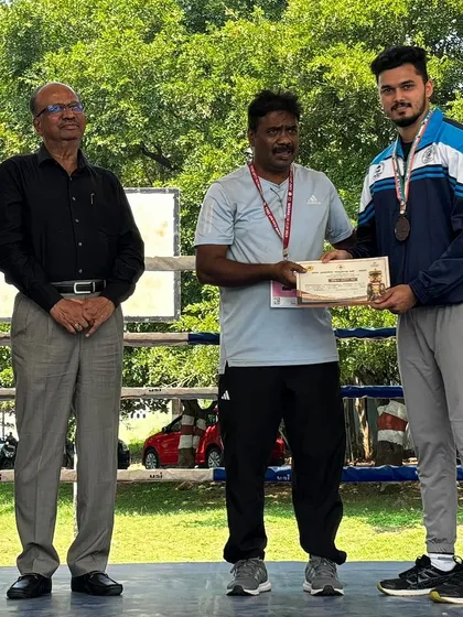 Receiving my bronze medal at the Dasara Games. Competing as a martial artist and boxer gives me firsthand experience that I use to make my clients' strength and conditioning programs more effective.