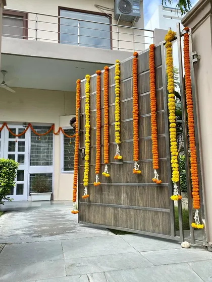 I believe a great first impression starts at the gate. For this commercial property entrance, I installed vertical garlands of fresh yellow and orange marigolds, creating a traditional and vibrant welcome for everyone who enters.