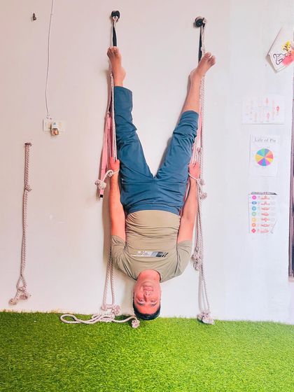 Using the Iyengar ropes for a deep spinal traction. This setup allows the body to hang freely, creating space between each vertebra. It's a very therapeutic way to practice inversions.