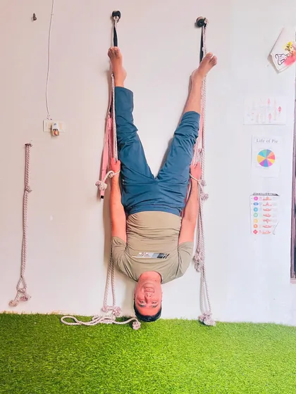 Using the Iyengar ropes for a deep spinal traction. This setup allows the body to hang freely, creating space between each vertebra. It's a very therapeutic way to practice inversions.