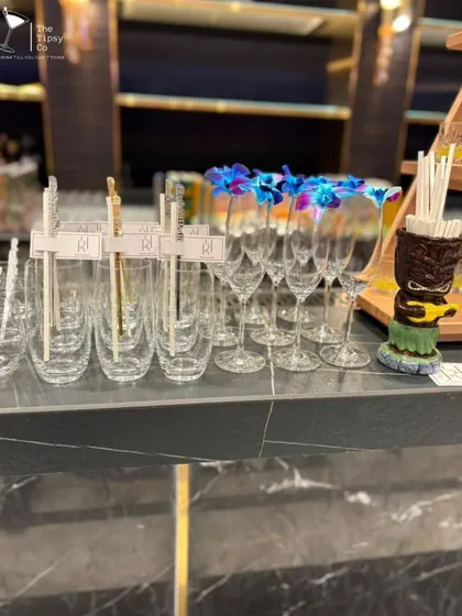 A close-up of our elegant glassware. We offer a variety of glasses to suit every drink, from champagne flutes garnished with orchids to highball glasses with custom stirrers.
