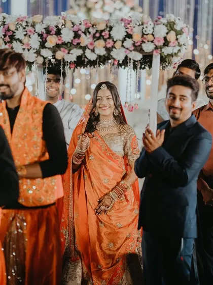 The bride's team eagerly awaits the groom's arrival. I coordinate both sides of the wedding party to build anticipation and make the meeting at the mandap even more special.