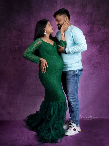 A sweet and loving gaze between partners. The contrast between her elegant green gown and his casual attire works beautifully.