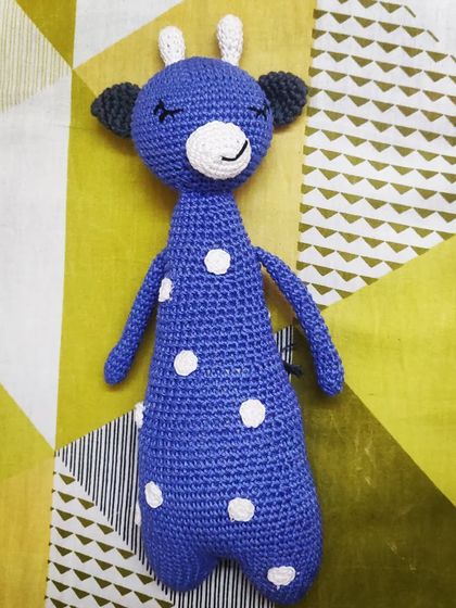 A custom-made giraffe in a beautiful blue with white polka dots. This piece shows how I can personalize your favorite animal toy with your choice of colors to make it truly one-of-a-kind.