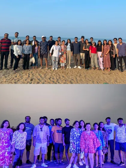 A group photo on the beach in Gokarna, capturing the beautiful sunset hues. Beach sunsets are a highlight of our coastal trips.