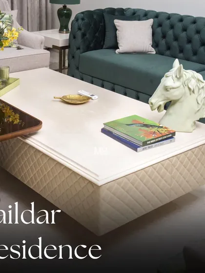 We believe a living room should be a statement of comfort. For the Zaildar Residence, we centered the design around this deep green velvet Chesterfield sofa, a timeless piece that exudes elegance. The entire space is a play on rich textures and a refreshing, nature-inspired color palette.
