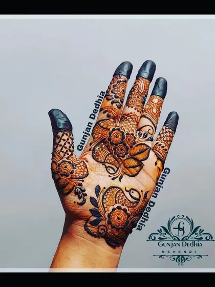 A beautiful single-hand design featuring a mix of floral and peacock motifs. The filled fingertips give it a classic, finished look.