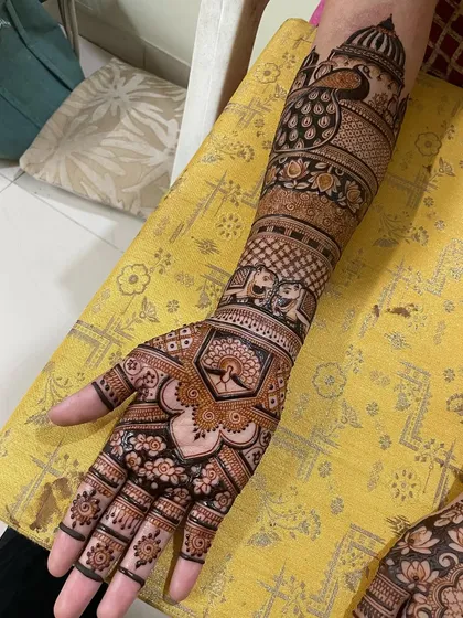 Another look at this beautiful bridal arm design. The combination of peacocks, elephants, and floral bands makes it a true work of art.
