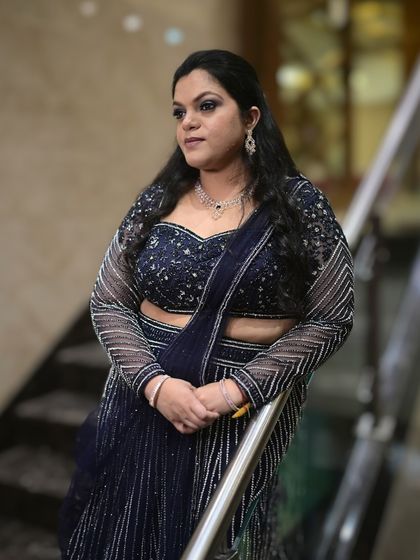 A confident and glamorous portrait. The makeup is polished and sophisticated, perfect for a grand wedding reception.