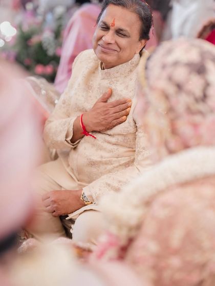 A father's pride and emotion. Removing color from this powerful moment amplifies the feeling, allowing the viewer to connect directly with his heartfelt expression.