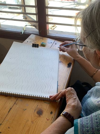 Our classes are open to everyone. Here, a senior student practices basic line work, proving that the desire to learn is timeless.