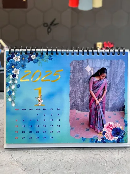 A still image of the blue floral themed desk calendar, showing the high-quality 300 GSM paper and sturdy white base stand.