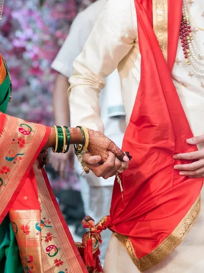 The tying of the knot, a symbolic gesture where the bride and groom's garments are tied together, signifying their union.