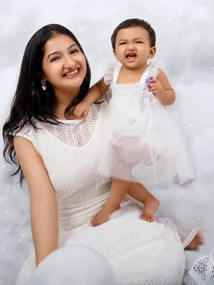 A family portrait in the clouds! This photo shows the parents joining their little angel in the dreamy, all-white setup.