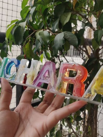 This custom resin name stand is so bright and cheerful. Each letter has a different color and contains real preserved flowers, making it a unique piece of decor for a desk or shelf.