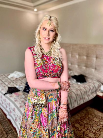A full view of the mehndi look, showing how the hairstyle complements the vibrant, colorful lehenga.