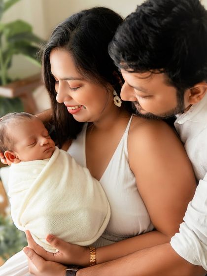 Another angle of the family embrace, capturing the mother's loving gaze and the father's protective hold.