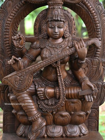 A detailed shot of the 35.5-inch Saraswathi, highlighting the intricate carving on her robes and the lotus base.