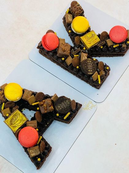 The full 'AK' monogram cake set for Archana Kochhar's birthday celebration.