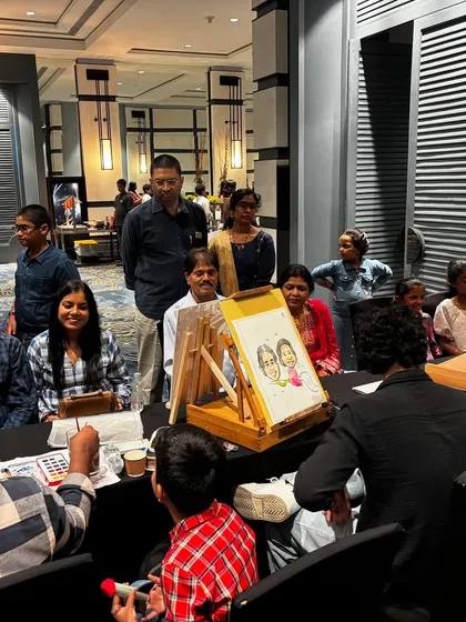 My live caricature station at a family event. It always becomes a popular spot where guests gather to watch the fun.