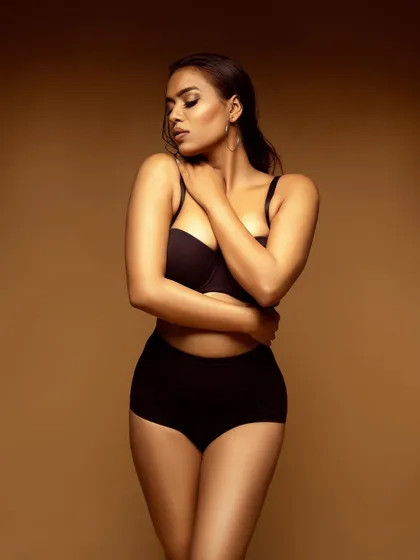A softer, more introspective pose that adds an element of grace to the lingerie shoot.