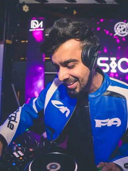 A smile of gratitude from behind my Pioneer DJ setup. Seeing the dance floor packed and feeling the vibe is the ultimate reward. This is the passion I bring to every performance.