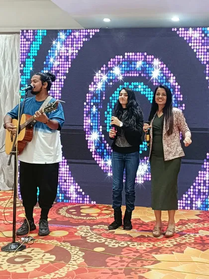 On stage with the talented unplugged band that performed at the 70th birthday celebration. Live music adds a soulful and classy touch to any milestone event.