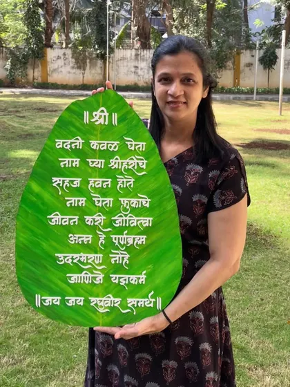 Here I am with a large, 24-inch 'Vadani Kaval' wall hanging, custom-made for a client in the US. This traditional Marathi prayer for mealtime looks beautiful in a dining area and brings a sense of gratitude to the home.