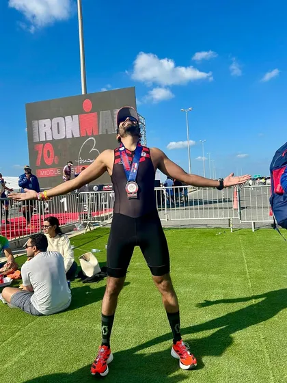 Pure elation at the Ironman 70.3 finish area. This is the reward for countless hours of swim, bike, and run training, a moment of personal triumph shared by the whole team.