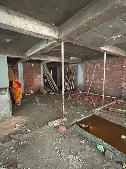 The basement level of the Mehrauli apartment complex under construction. This raw image shows the concrete columns and shuttering supports, the backbone of the multi-story structure.