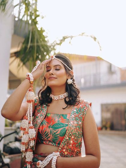 A sun-kissed shot of our beautiful bride on her Haldi day. The makeup is soft and natural, letting her happiness shine through.