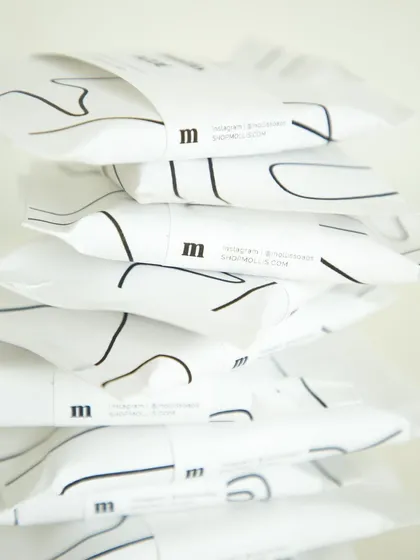 A stack of the elegantly packaged corporate gifts for Airbnb.