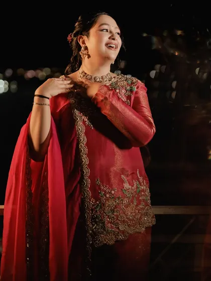 A joyful, candid moment. Her radiant smile and glowing skin are the highlights of this soft and dewy festive makeup look.