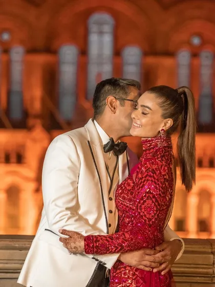 A happy couple shares a kiss at their London reception. Capturing these moments of pure joy is the ultimate reward of our work.