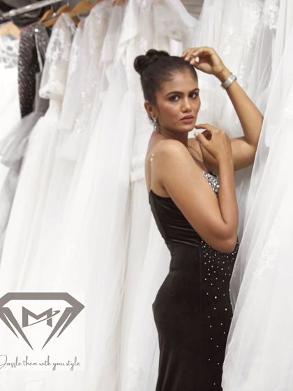 A side view of the midnight sparkle velvet gown, showing how it hugs the silhouette before cascading to the floor.