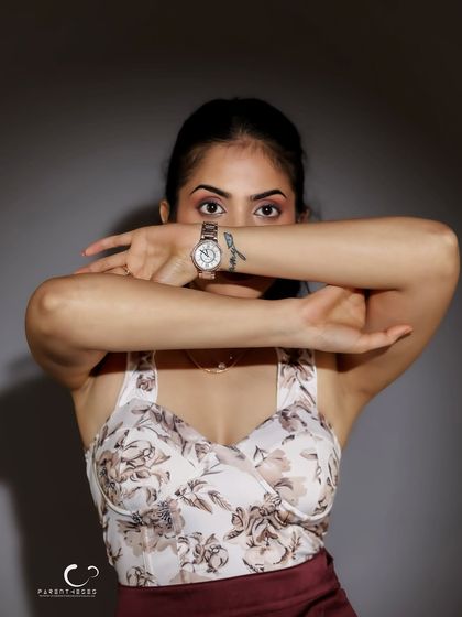 A creative and powerful pose where the arms create a frame, drawing all attention to the eyes. It's a statement of hiding and revealing, of mystery and confidence.