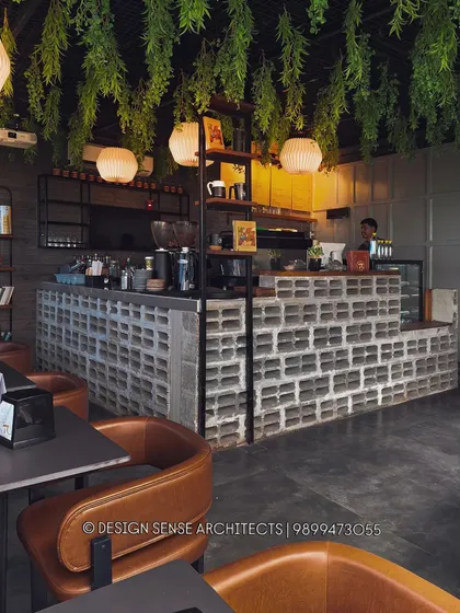 I enjoy playing with raw materials to create something unique. For this cafe, we used exposed concrete blocks for the main counter and hung lush greenery from the ceiling to create a cool, industrial-chic vibe that feels both edgy and natural.