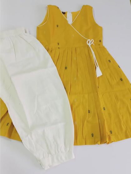 Here is the Abhirami set in a beautiful turmeric yellow with grey buttis. This two-piece set is so versatile; the top and pants can be mixed and matched with other items in your child's wardrobe.