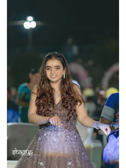 A candid moment of a guest arriving at the sangeet, her smile full of warmth and excitement for the night ahead.