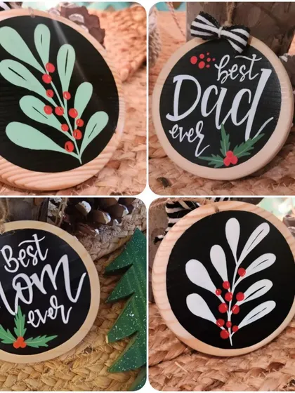 Hand-painted Christmas ornaments for the "Best Mom" and "Best Dad," complete with festive holly details.