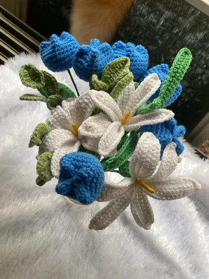 Another view of the ocean blue bouquet, showing the arrangement of the blue tulips and white lilies from above.