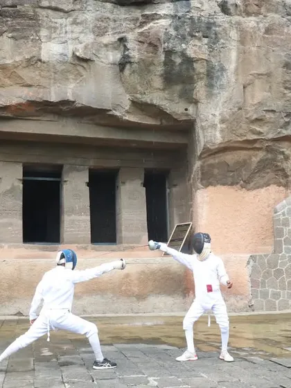 Our fencers practice in front of the historic caves in Aurangabad. This wide shot shows the full context of the unique environment, blending sport with heritage.