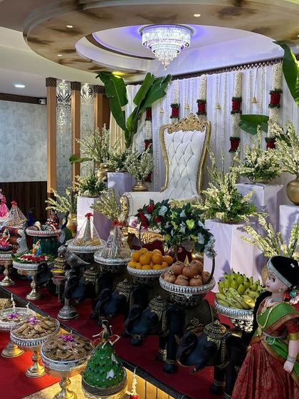 A side view of the white and red stage, showing the line of black elephant props.