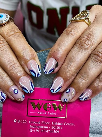 Ward off bad vibes with style. This creative design features the classic evil eye motif combined with modern, abstract lines in shades of blue and white.